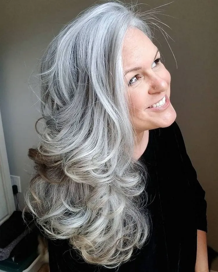 side swept long silver hair long gray hairstyles for women over 50