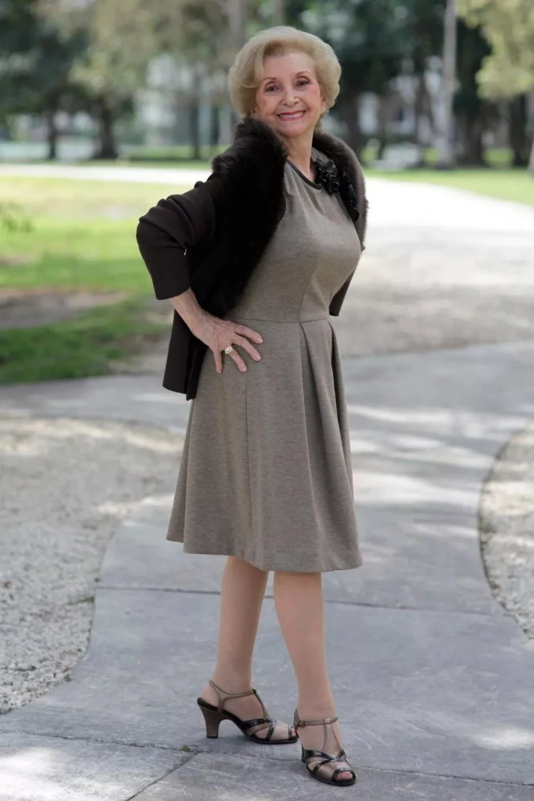 beige knee length simple dress and black coat