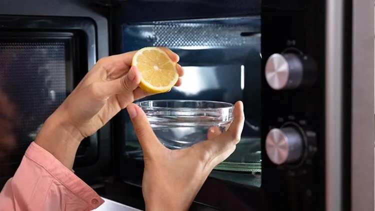 bowl of water and lemon juice to clean a microwave