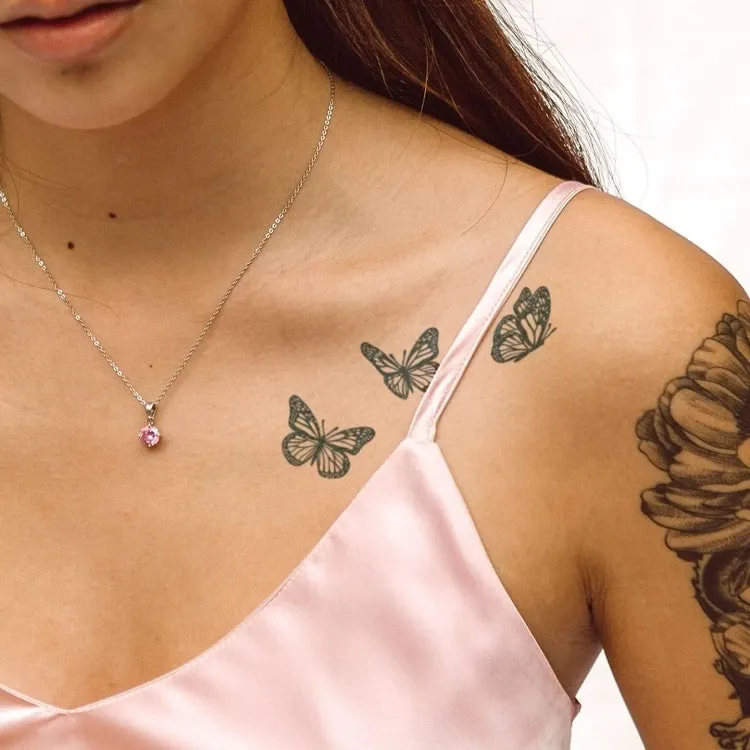 Minimalist branch tattoo on the collarbone.