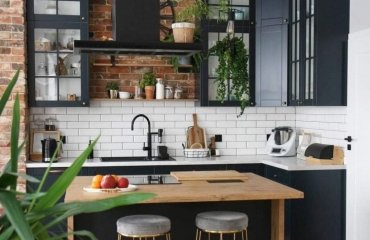 cozy kitchen in black wooden elements brickwall white backsplash and countertop