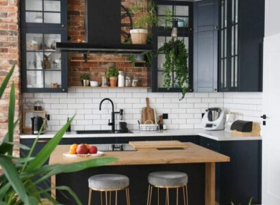 cozy kitchen in black wooden elements brickwall white backsplash and countertop