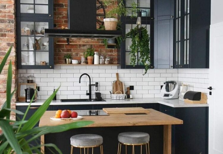 cozy kitchen in black wooden elements brickwall white backsplash and countertop
