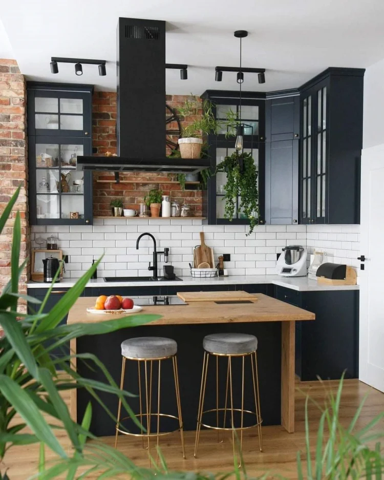 cozy kitchen in black wooden elements brickwall white backsplash and countertop