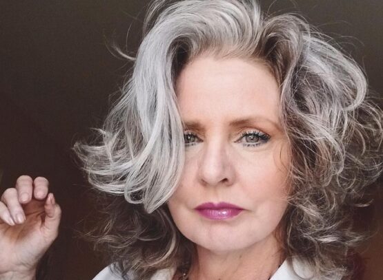 curly layered medium length hairstyle for over 60 gray money piece textured hair
