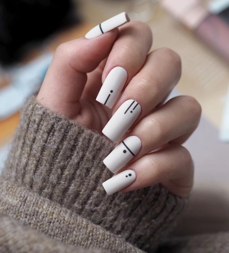 geometric nail art long light beige nails with black lines
