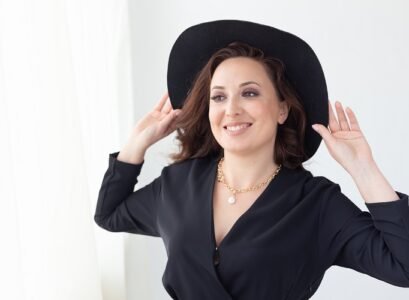 portrait of a beautiful graceful woman in elegant hat with a wide brim. beauty and fashion concept.