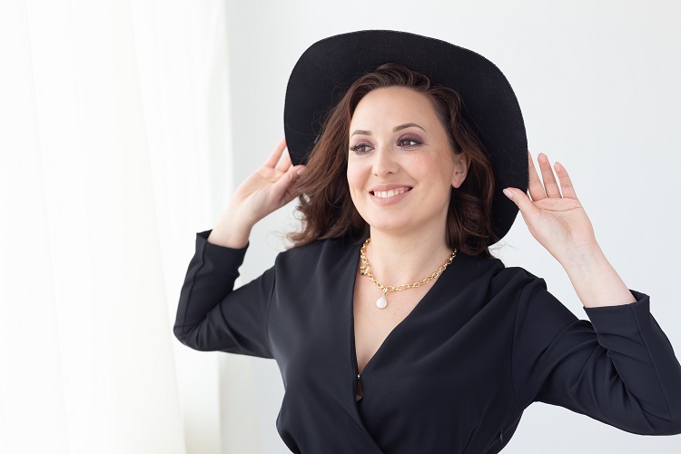 portrait of a beautiful graceful woman in elegant hat with a wide brim. beauty and fashion concept.