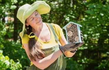 gardener is holding a house for bees