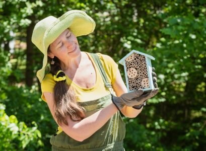 gardener is holding a house for bees