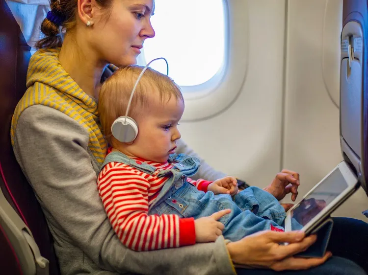 how to calm a crying baby on a plane give them a book or a toy
