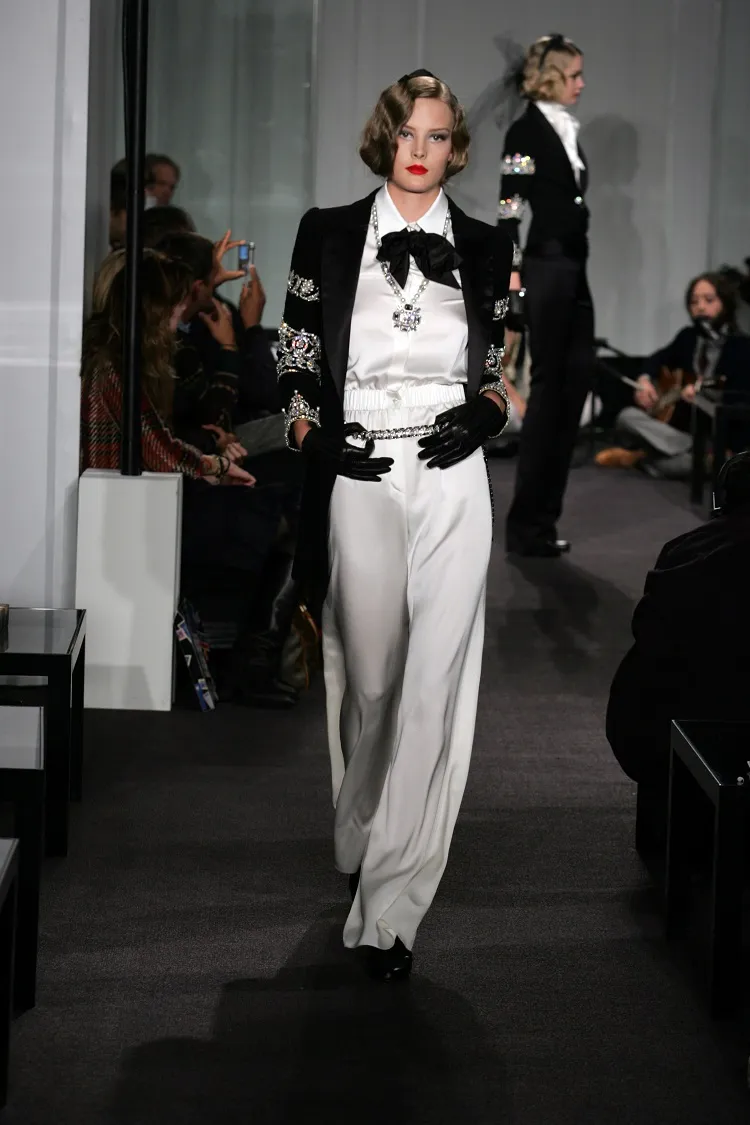 karl lagerfeld fashion homage satin white pants black bow tie shirt diamond jewelry red lipstick french glam