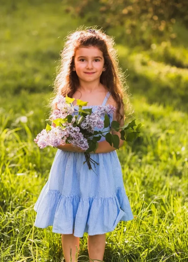 little girl in a white and blue striped dress