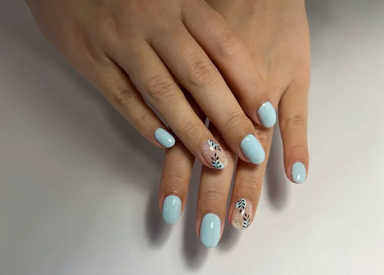 manicure for women over 50 pastel blue black leaves drawing short oval nails