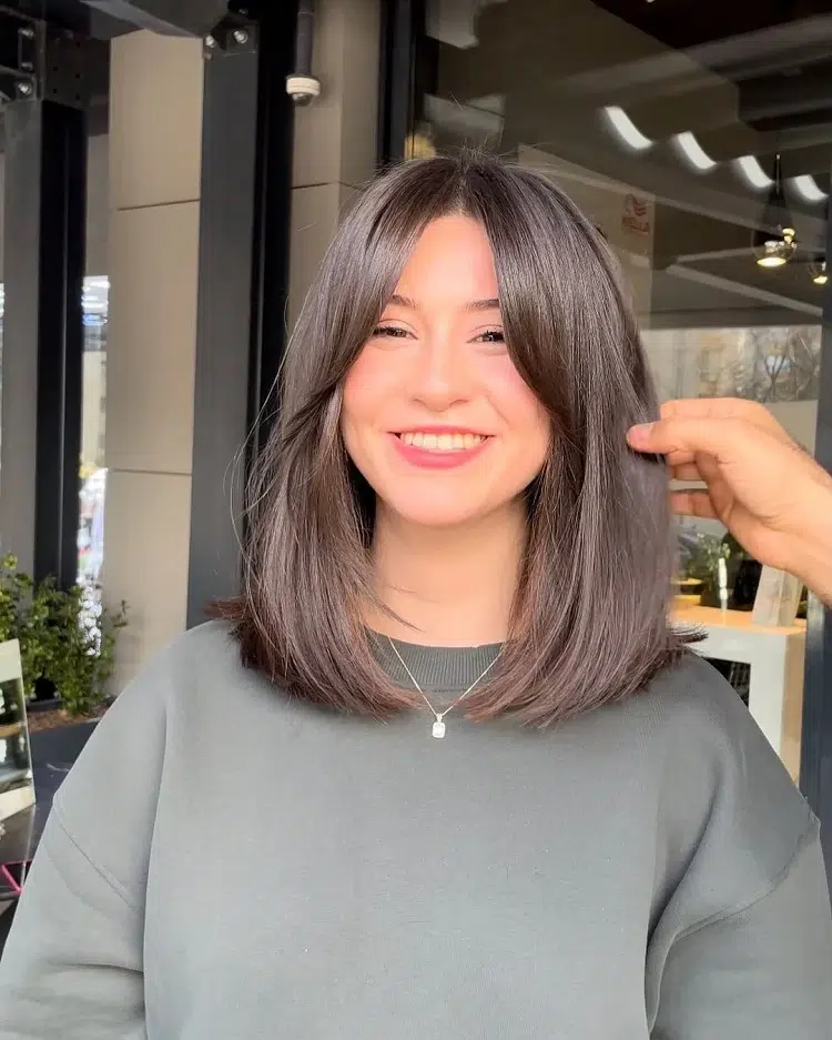 medium length bob haircut with curtain bangs 2023