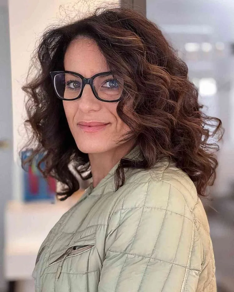 mid length thick curls for women over 40 with glasses