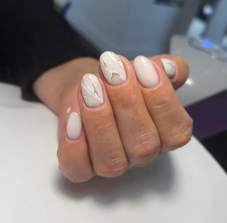 milky white marble gold accents short oval shape nails mature women nail art ideas