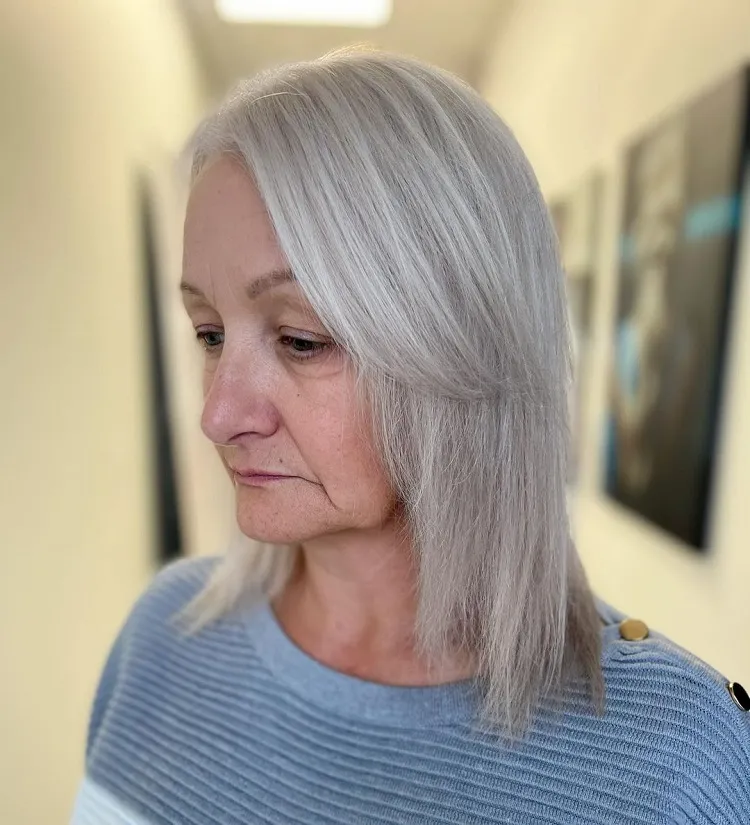 pearl platinum blonde gray blending silver hair medium length layered side swepth curtain bangs women over 60 hairstyle