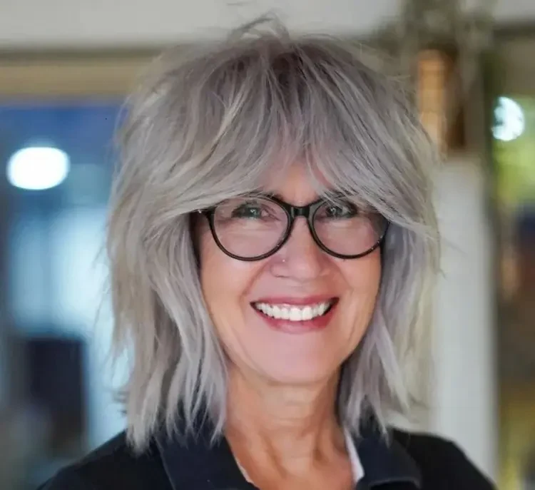 shaggy hairstyle for women over 50 with curtain bangs