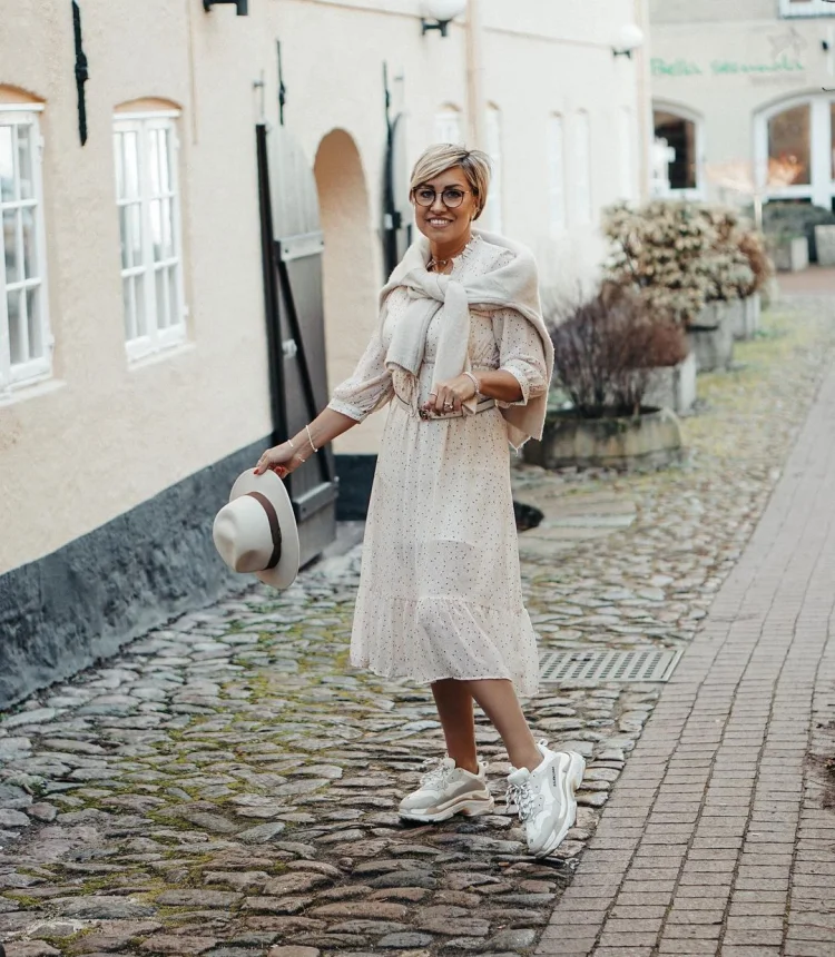 trendy dress in neutral color and black dots white sneakers