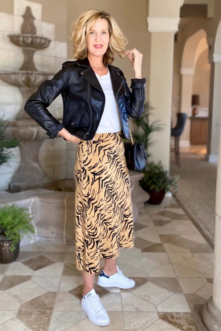 trendy midi skirt and white sneakers white blouse and leather jacket