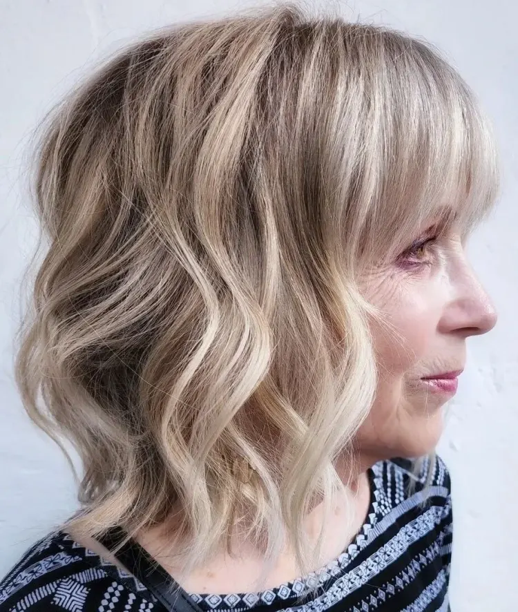 wavy shoulder length hairstyle with full bangs shoulder length haircuts for women