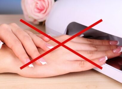 beautiful,woman,hands,and,lamp,for,nails,on,table,close