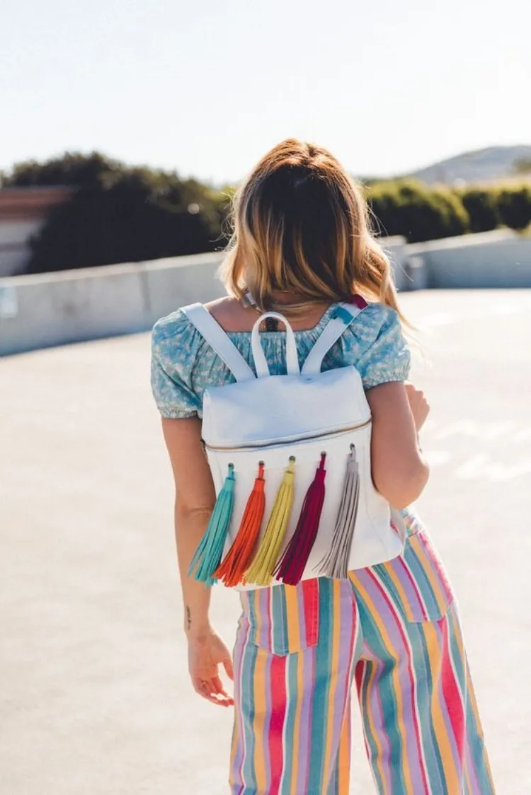 white leather backpack colorful tassels coachella outfit ideas 2023