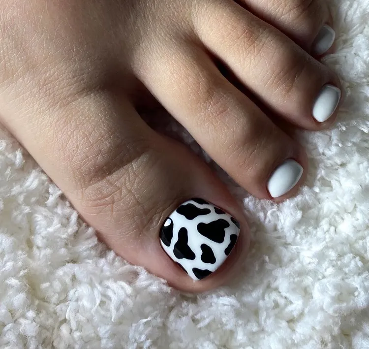 white polish animal cow print toe nail design