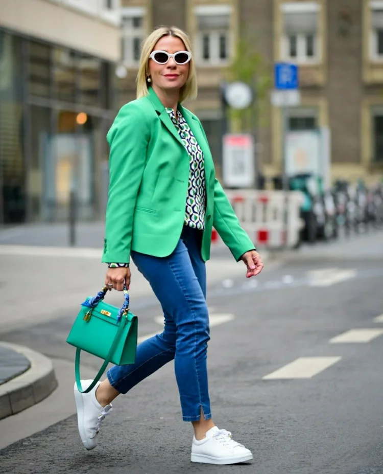 white sneakers blue jeans green handbag and blazer
