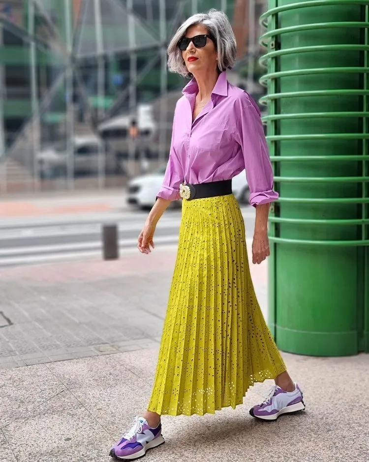 combine a maxi pleated skirt with a shirt and sneakers for a casual look