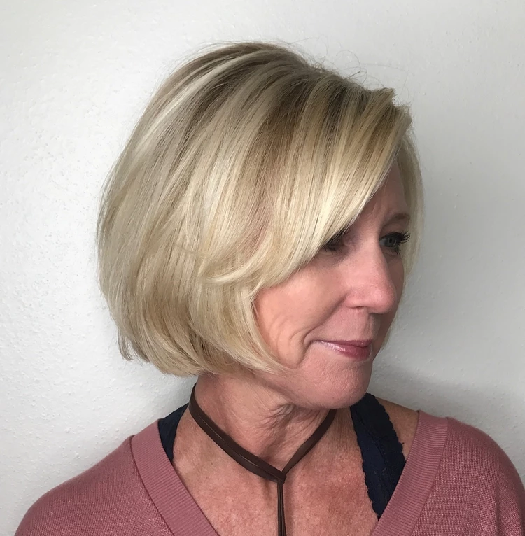 blonde layered bob with side bangs 2023 haircuts for older women