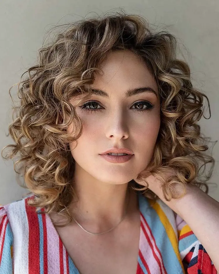 curly bob hairstyle for round face with side bangs