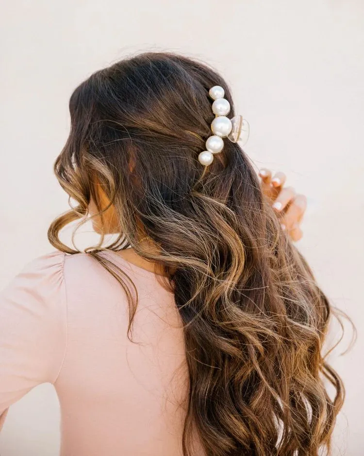 old money curly hairstyle with pearl hair clip