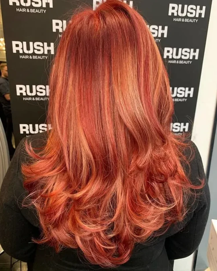 red and strawberry blonde highlights on long hair