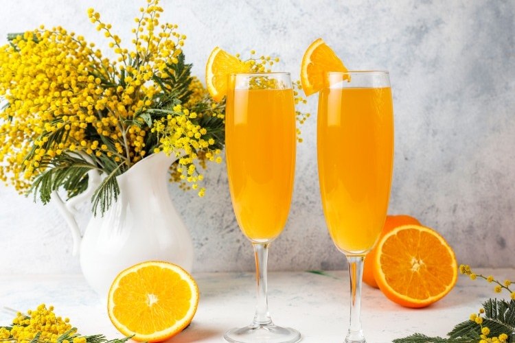 homemade refreshing orange mimosa cocktails with champaigne