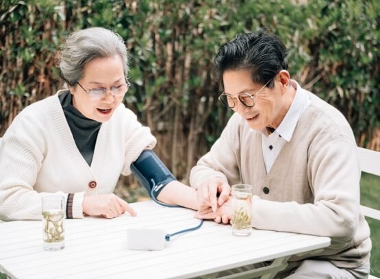 senior couple checking their blood pressure in the yard