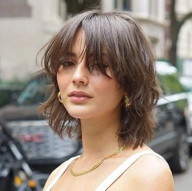 short layered wolf cut with bangs hairstyle trends 2023 round face shape