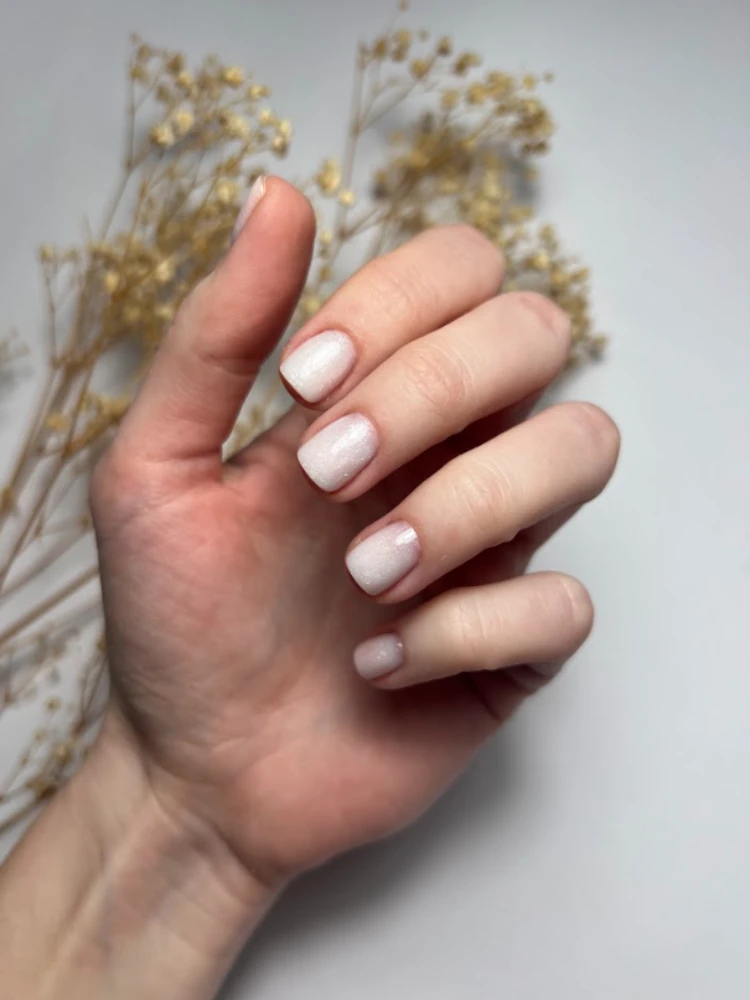 short rounded square shape nails milky white color with subtle glitter particles