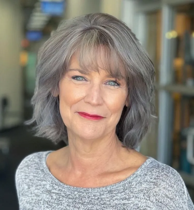 shoulder length gray short hairstyle with bangs for older women