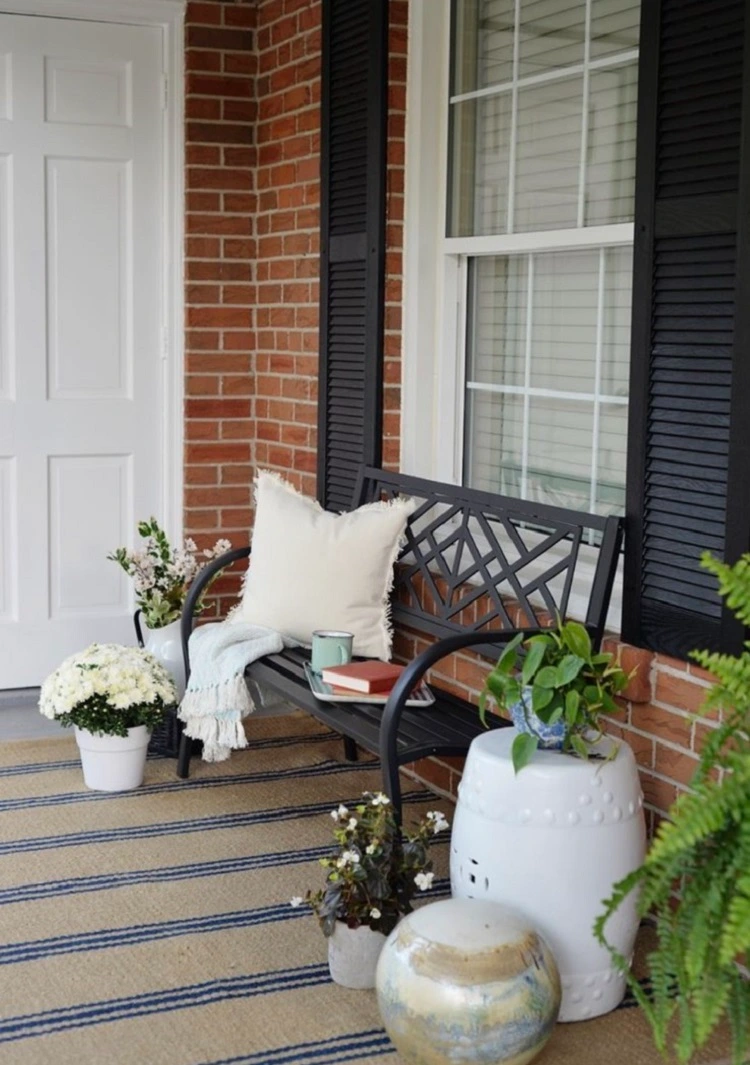 simple small front porch idea with a bench and pillows