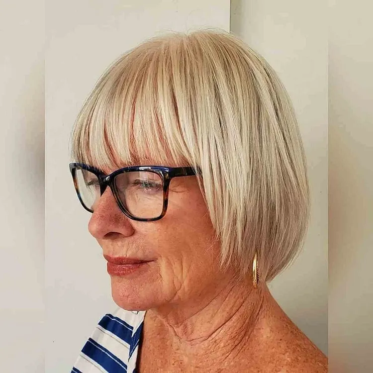 textured bob with bangs for women over 50 with glasses