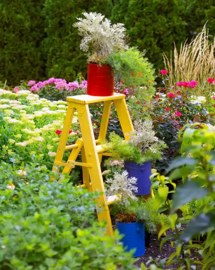 unique garden decor ideas old ladder and paint containers