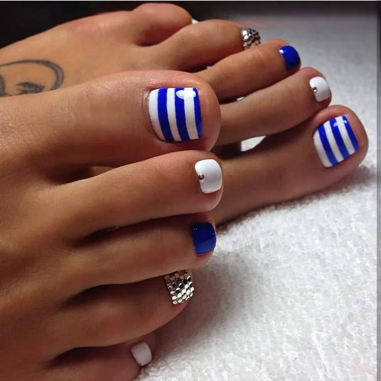 white blue stripes silver glitter sea motif summer pedicure design idea 2023