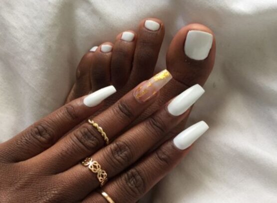 white matching manicure pedicure long ballerina nails gold rings dark skin woman