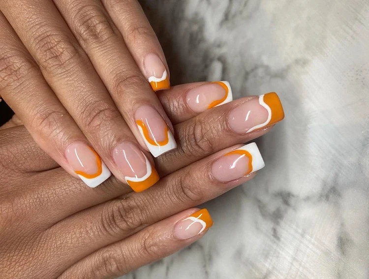 abstract french tip nails 2023 orange and white short square