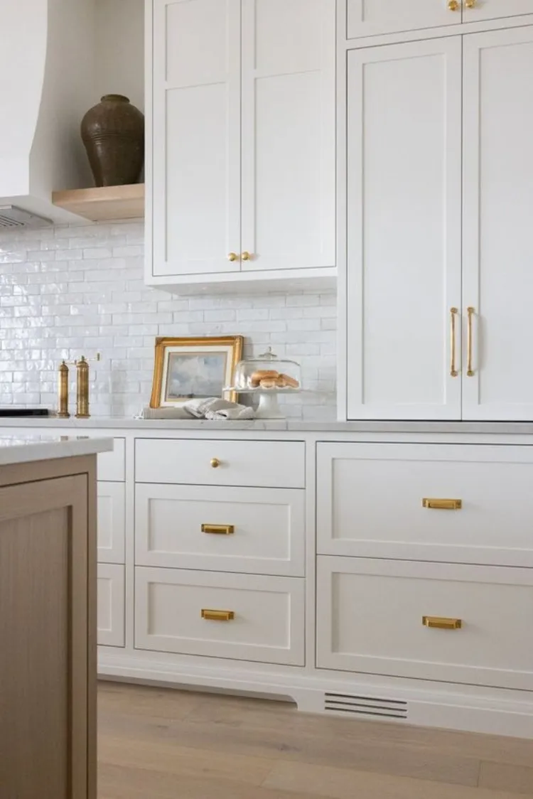 all white kitchen cabinets mixed shape size brass hardware diy home renovations on a budget