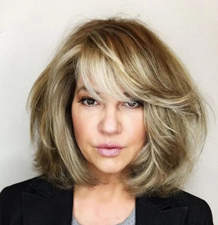 blowout bob hairstyle with side swept bangs over 50