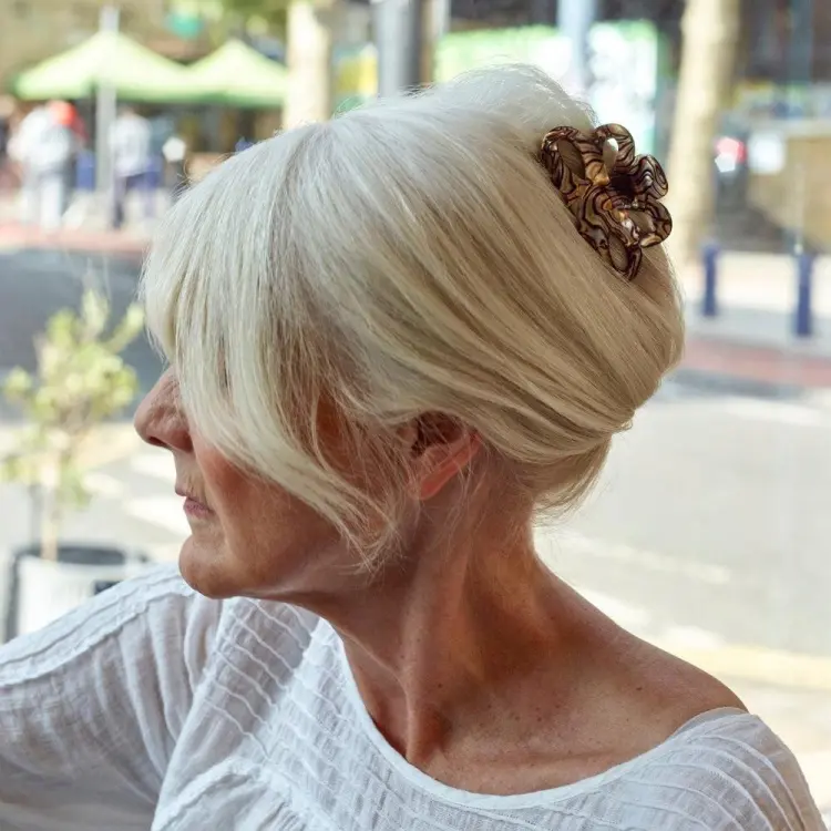 bun hairstyle for women over 50 with gray hair