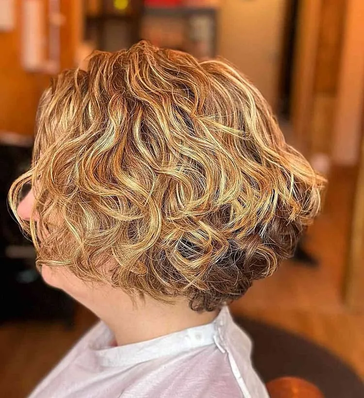 curly blonde bob with graduation for women over 60